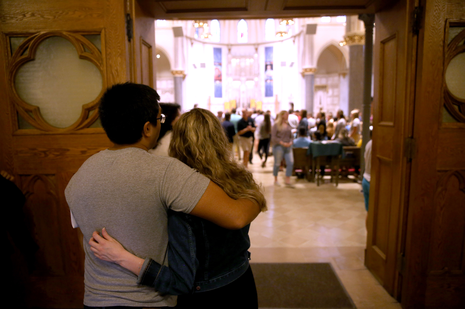 Students embracing at the Mass of the Holy Spirit